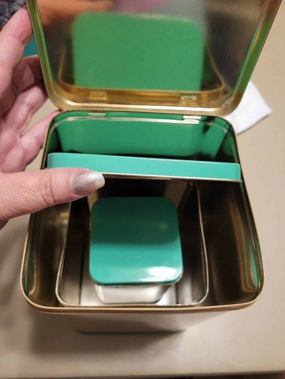 LASLO - Set of 3 Nesting Tan Metal Canisters with Green Lids and Stripes.